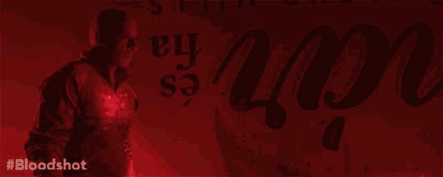 a man is standing in front of a red sign that says " bloodshot "