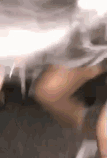 a close up of a person 's face with smoke coming out of their mouth