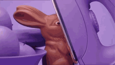 a purple iron is being used to iron a chocolate bunny