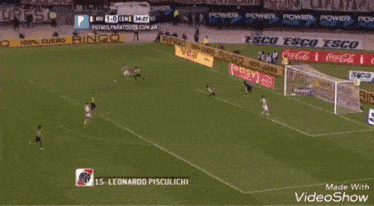 a soccer game is being played on a field with advertisements for coca cola and ringo ringo