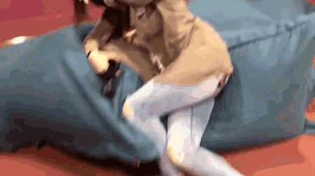 a woman is sitting on a blue bean bag chair .