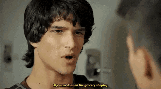 a young man is talking to another man in a bathroom .
