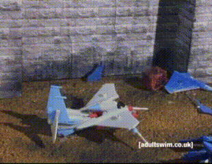 a toy airplane is laying on the ground with adultswim.co.uk written in the corner