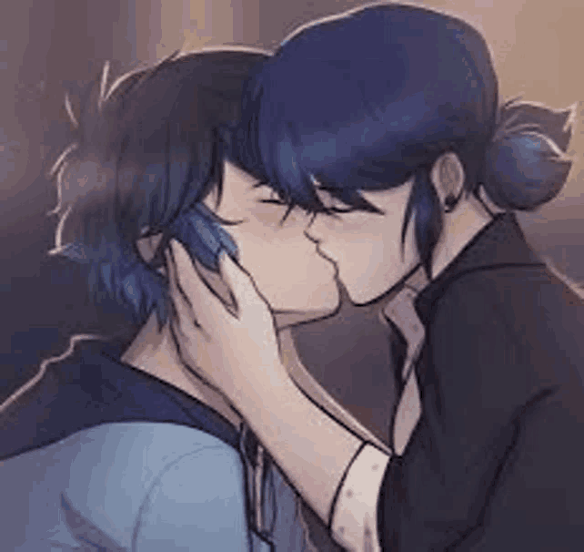 a man and a woman are kissing in a room .