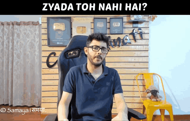 a man sitting in a chair with the words zyada toh nahi hai written on the bottom