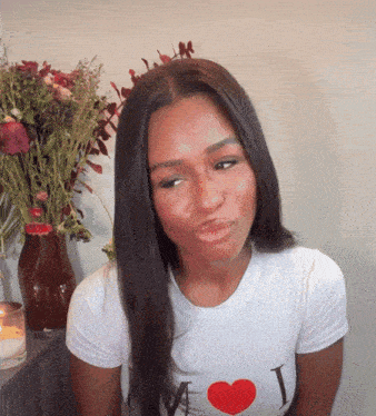 a woman wearing a white t-shirt that says i love m on it