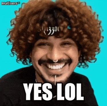 a man with curly hair and a nose ring is smiling and saying yes lol