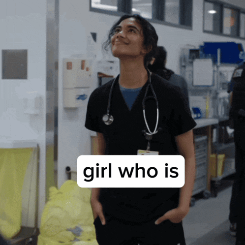 a woman with a stethoscope around her neck is standing in a hallway with a sign that says girl who is