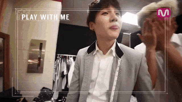 a man in a suit and white shirt with the words play with me on the bottom
