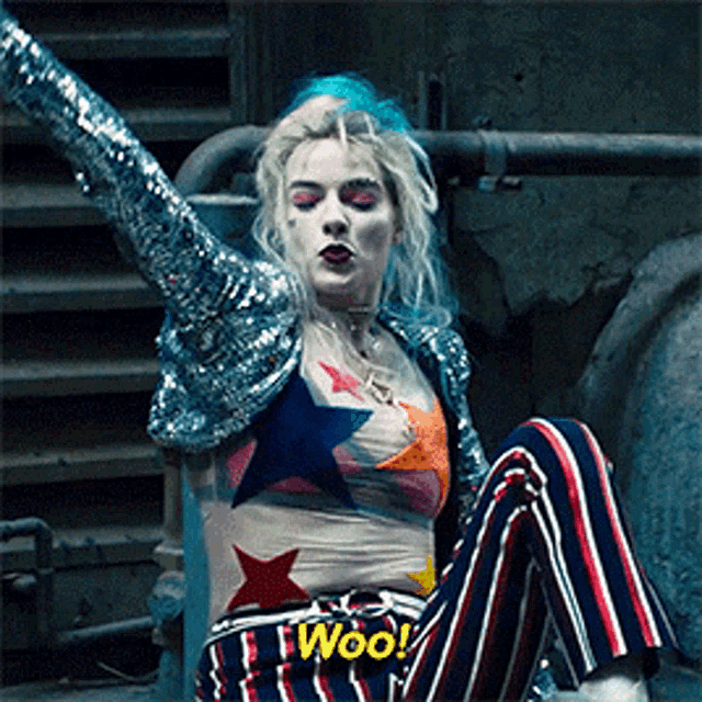 a woman in a sequined top and striped pants says woo