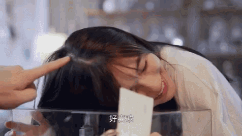 a woman with chinese writing on her face is being touched by a man 's finger