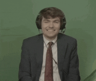 a man in a suit and tie is wearing headphones and a headset .