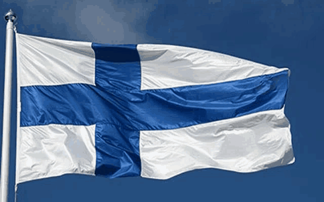 a blue and white flag is flying in the wind against a blue sky