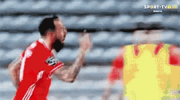 a soccer player in a red jersey with the number 8 on it