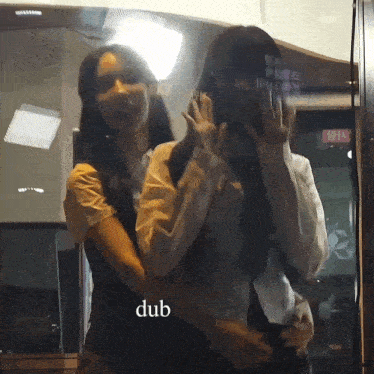 a couple of women standing next to each other with the word dub on the bottom right