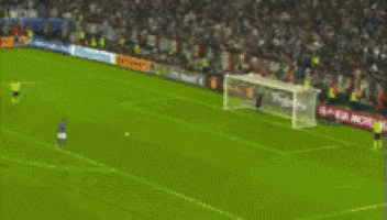 a soccer player wearing a number 7 jersey stands in front of a crowd