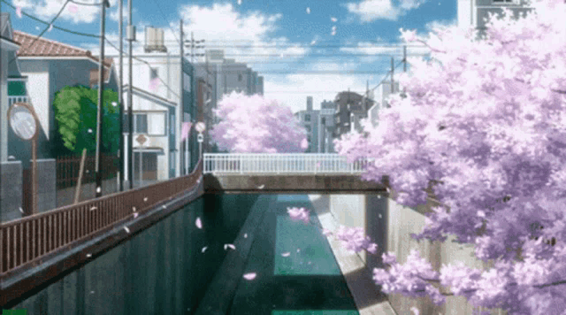 a bridge over a river with cherry blossom trees in the foreground