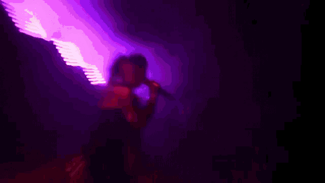 a man is singing into a microphone while another man plays a keyboard in the background