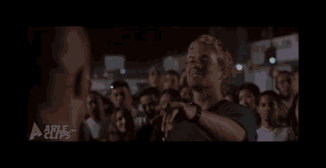 a man pointing at another man in front of a crowd that says able clips on the bottom right