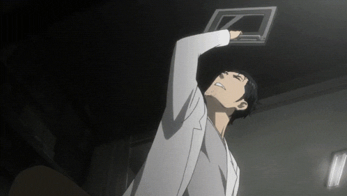 a man in a lab coat looks up at the letter z on the ceiling