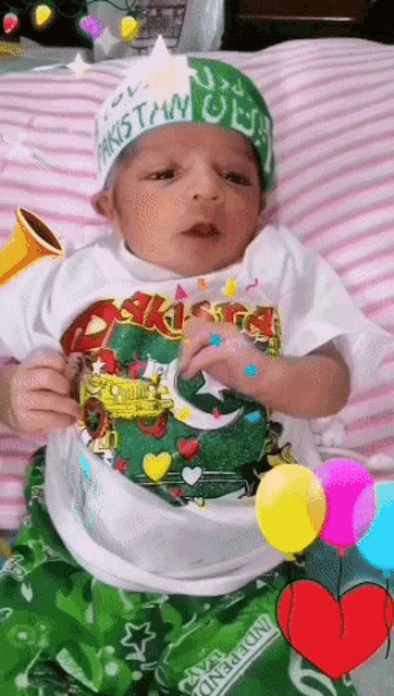 a baby wearing a hat that says pakistan