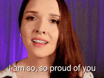 a woman says i am so so proud of you in front of a purple background