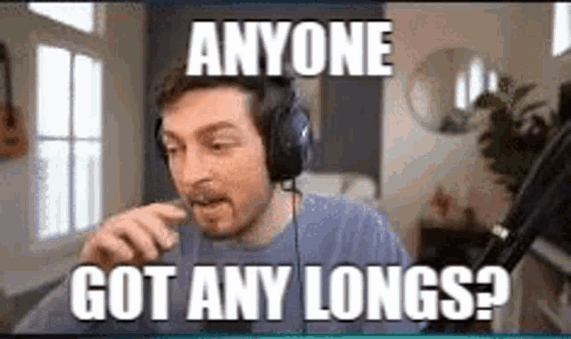 a man wearing headphones is sitting in a living room .