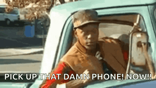 a man is driving a truck and says pick up that damn phone now