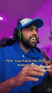 a man with a beard wearing headphones and a blue hoodie says " pov : your friend has 2025 brain rot "