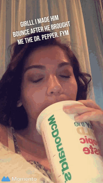 a woman drinking from a cup that says mcdonalds