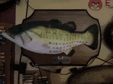 a big mouth billy bass is displayed on a wooden plaque
