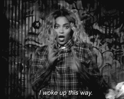 a black and white photo of a woman wearing a plaid shirt saying i woke up this way
