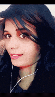 a close up of a woman 's face with earphones around her neck