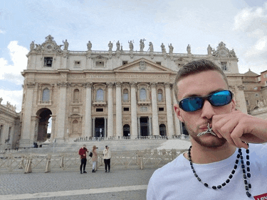 a man wearing sunglasses and a necklace with the word levi on the front