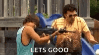 a man and a boy are playing with guns in a playground and the boy is pointing a gun at the man .