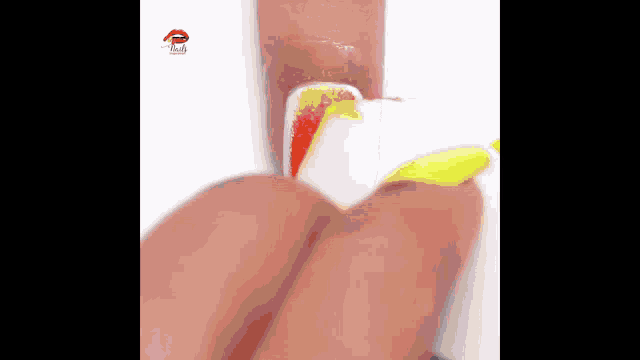 a close up of a person 's nails with a candy corn design on them