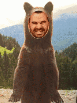 a bear with a man 's face in it 's mouth