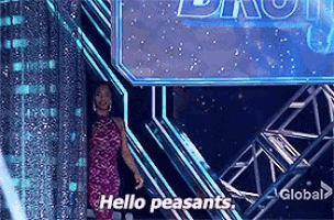 a woman in a pink dress is standing in front of a sign that says hello peasants