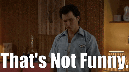a man wearing a shirt that says ' george ' on it says that 's not funny