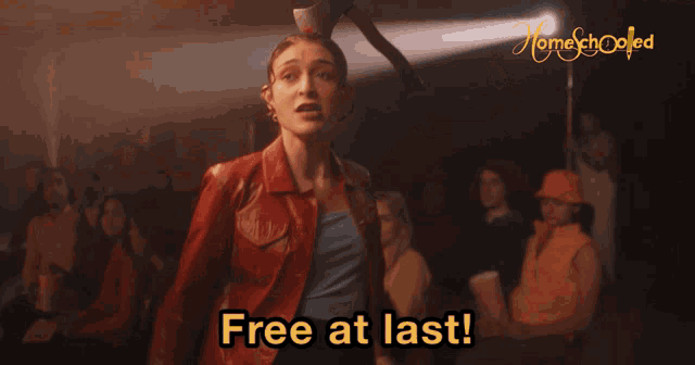 a woman in a red leather jacket is screaming with the words free at last behind her