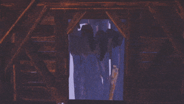 a window in a wooden structure shows a purple and white painting