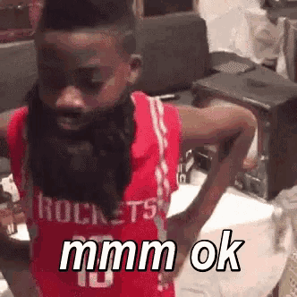 a boy with a beard wearing a rockets jersey says mmmm ok
