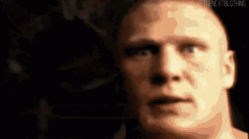 a close up of a man 's face in a dark room with a blurry background .
