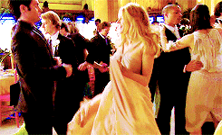 a woman in a white dress is dancing with a man