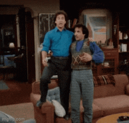 two men standing next to each other in a living room with imgflip.com at the bottom