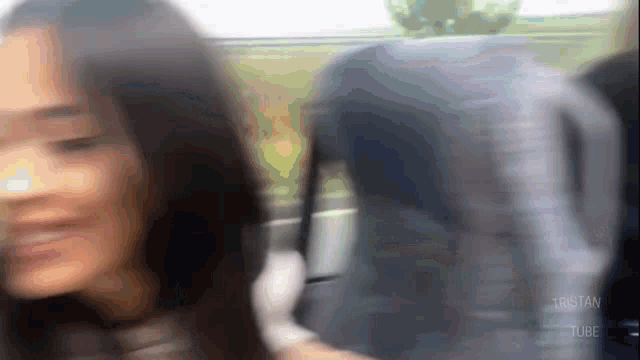 a blurry picture of a woman with tristan tube written on the bottom right
