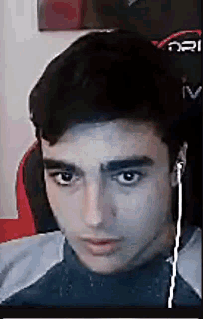 a young man wearing headphones is sitting in a chair .