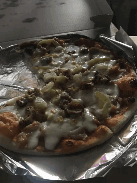a pizza with a slice taken out of it is in a box