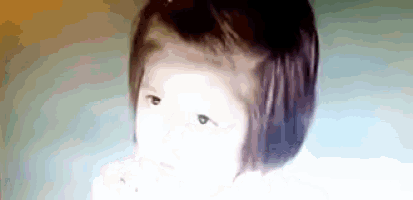 a close up of a child 's face with a blurred background .