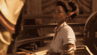 a woman with a bun on her head is sitting in a washing machine